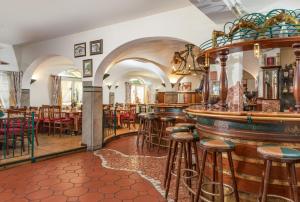 a bar with tables and stools in a restaurant at Hotel Restaurant Lebzelter in Altenmarkt im Pongau