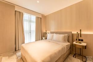 a bedroom with a large bed and a window at Super Spacious 3BR with Maid's Room in Five Palm in Dubai