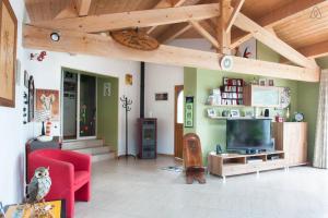 uma sala de estar com um sofá vermelho e uma televisão em Belle et Grande demeure prés de La Rochelle em Sainte-Soulle