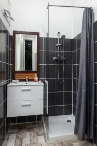 a bathroom with a white sink and a shower at L'Aix Capade Zen in Aix-les-Bains