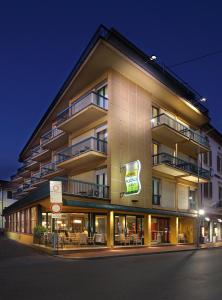 a large building with a sign on the side of it at Hotel Nuovo Savi in Montecatini Terme