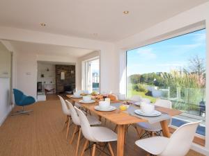 a dining room with a table and chairs and a large window at 4 Bed in Brixham 76402 in Brixham