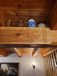 a wooden shelf with pots and pans on a ceiling at Dom w Górach Sowich Niedźwiedzia Gawra, Michałkowa in Michałkowa