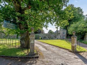 a gate in front of a castle with a sign at 1 Bed in Clearwell 78375 in Clearwell