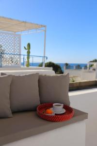 a tray with a bowl of fruit and a cup of coffee at Dar AZUR HAMMAMET FORT in Hammamet