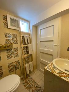 a bathroom with a toilet and a sink at Dar AZUR HAMMAMET FORT in Hammamet