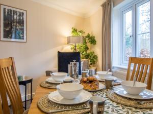 a dining room with a table with dishes on it at 3 bed in Bampton 77931 in Bampton