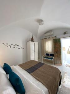 a bedroom with a large bed with blue pillows at Dar AZUR HAMMAMET FORT in Hammamet