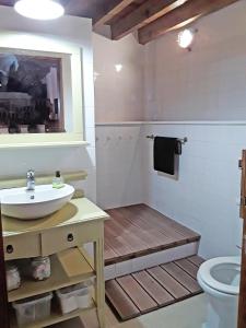 a bathroom with a sink and a toilet at Casa dos Botes in Santa Cruz das Flores