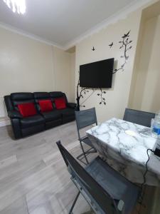 a living room with a couch and a table at House In the heart of valleys in Ebbw Vale
