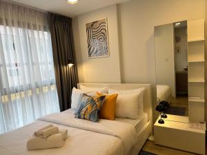 a bedroom with a bed with a teddy bear on it at New Cosy Apartment at Marvest Huahin City Center in Hua Hin