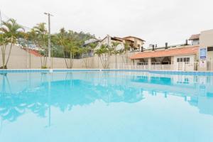 a large pool with blue water in front of a building at Ao lado do Shopping e da Beiramar Norte GB1800 in Florianópolis