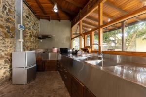 a kitchen with a stainless steel counter and a sink at Villa Diyathra in Tangalle
