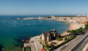 an aerial view of a beach with boats in the water at EVOLUTION Cascais-Estoril Hotel in Estoril