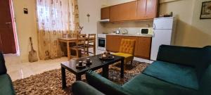 a living room with a couch and a table and a kitchen at La Casa in Mesinón