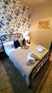 a bedroom with a bed with towels on it at Potter's Place at Newcastle under Lyme, Close to Keele University in Longport