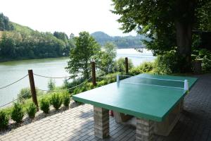 a ping pong table with a view of a river at Chata Bystřička in Velká Lhota