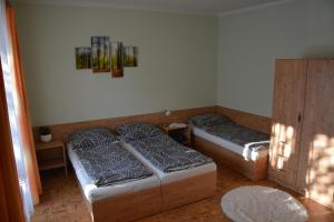 a room with two beds and a cabinet at Chata Bystřička in Velká Lhota