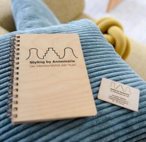 a notebook sitting on top of a bed at B&B De Korenbloem in Noordbroek