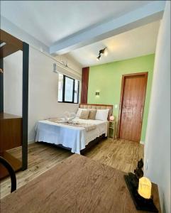 Schlafzimmer mit einem Bett und einem Fenster in der Unterkunft Apartamentos - Estúdios in São José