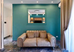 a couch in a room with a green wall at Serenity Suite in Montecatini Terme