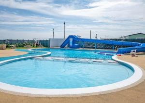 a large swimming pool with a water slide at The Vale @Barmston in Barmston