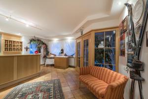 a living room with a couch and a kitchen at Pension Prack in Brunico