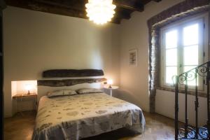 a bedroom with a bed and a large window at Il Colombee in Montevecchia