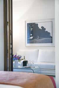 a living room with a couch and a table at Hospes Puerta de Alcalá, a Member of Design Hotels in Madrid