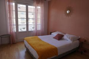a bedroom with a bed and a large window at 3 Bedrooms - Spacious and friendly - City Center in Caen