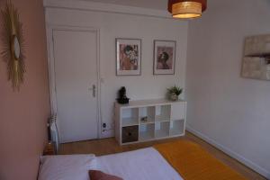 a bedroom with a bed and a door and a table at 3 Bedrooms - Spacious and friendly - City Center in Caen