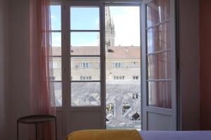 a large window with a view of a building at 3 Bedrooms - Spacious and friendly - City Center in Caen