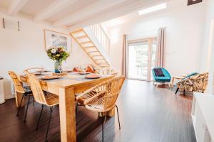 a dining room with a wooden table and chairs at Chalets et gîtes d'Orlu in Orlu