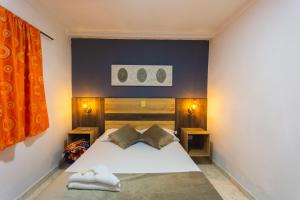 Postel nebo postele na pokoji v ubytování Hotel Real Guatapé + 37 fotografií