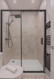 a shower stall in a bathroom with a toilet at 2 Bed Garden Flat at Primal Estates Short Lets in Brighton in Brighton & Hove