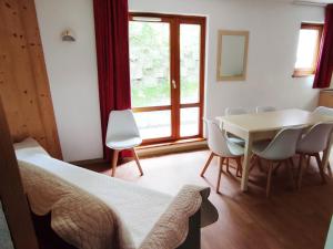 a bedroom with a table and chairs and a dining room at Appartement Saint-François-Longchamp, 3 pièces, 8 personnes - FR-1-635-84 in Saint-François-Longchamp