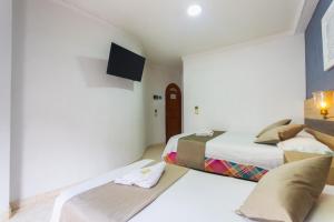 Letto o letti in una camera di Hotel Real Guatapé