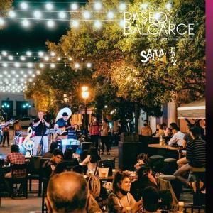 a group of people sitting at a restaurant with a band at ANDÉN FMA-Coliving in Salta