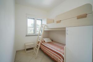 Ένα ή περισσότερα κρεβάτια σε δωμάτιο στο Residence Emmesse appartamenti stardard
