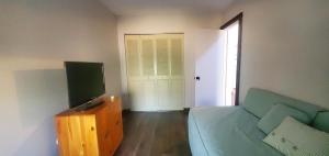a living room with a couch and a television at Gateway Condo A25 in Mendon