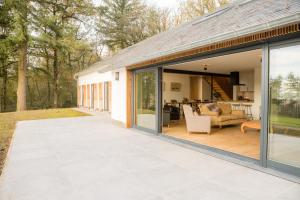 an open patio with sliding glass doors and a house at Gîte de Brohimont Vakantiehuis - Exceptional Cottage location - Uitzonderlijke locatie in Houyet