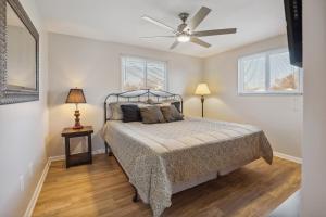 a bedroom with a bed and a ceiling fan at Massillon Vacation Rental with On-Site Pond Access! in Massillon