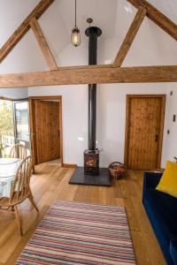 sala de estar con chimenea y sofá azul en Hay Barn en Winterton-on-Sea