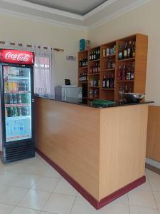a coca cola counter in a store with a refrigerator at Hotel Double N - Kisumu in Kisumu