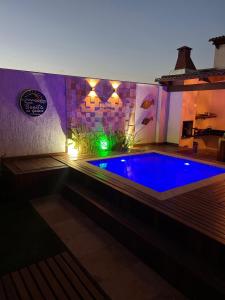 a swimming pool in a house at night with lights at Pousada Bonita do Gostoso in São Miguel do Gostoso