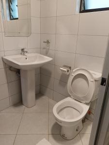 a bathroom with a toilet and a sink at Hotel Double N - Kisumu in Kisumu
