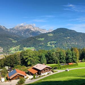 an aerial view of a house with mountains in the background at Pension Rennlehen in Berchtesgaden