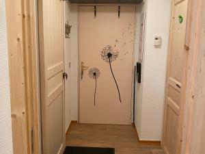 a hallway with a door with dandelions on the wall at Appartement Saint-François-Longchamp, 2 pièces, 5 personnes - FR-1-635-114 in Saint-François-Longchamp