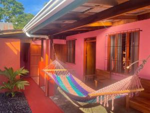 a hammock hanging from the side of a house at Casa Nativo Spring Arenal in Fortuna