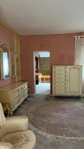 a living room with a dresser and a mirror at Pension Highway Ferienwohnung Osnabrück in Osnabrück